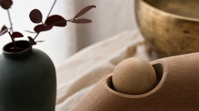 Abstract still life: two smooth wooden spheres fitted into a carved socket, like a joint